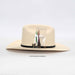 Beige cowboy hat with decorative band on a white background
