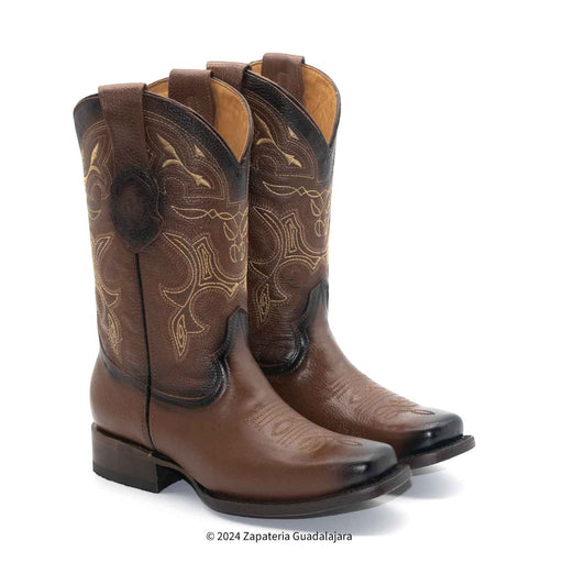 Pair of brown cowboy boots with intricate designs on a white background