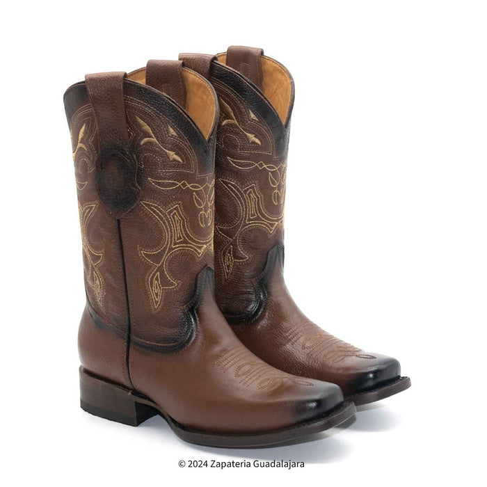 Pair of brown cowboy boots with intricate designs on a white background