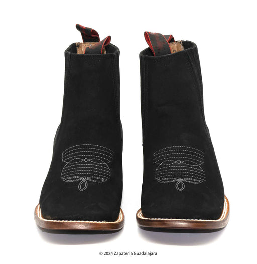 Pair of black boots with decorative stitching on a white background