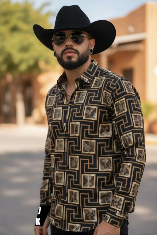 Man wearing a black cowboy hat, sunglasses, and a patterned shirt outdoors.