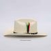 Beige cowboy hat with feather detail on a light gray background