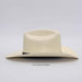Beige cowboy hat with a brand logo on a light gray background