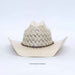 A light beige woven straw cowboy hat with a decorative dark band and a small central emblem, photographed against a clean white background.