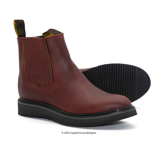 Brown leather boot with black sole on a white background