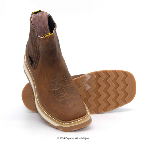 A pair of brown pull-up leather work boots with a square soft toe and double density sole.
