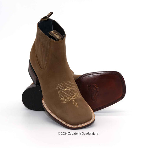 Brown leather boot with embroidery on a white background