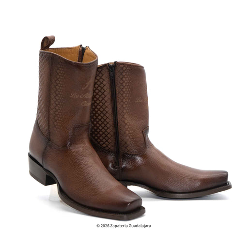 Pair of brown leather boots with textured design on a white background
