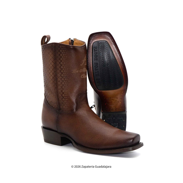 Brown cowboy boots with a textured pattern on a white background