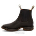 Black Chelsea boot with brown sole on a white background