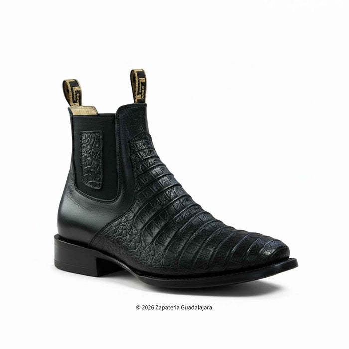 a pair of black cayman belly leather boots