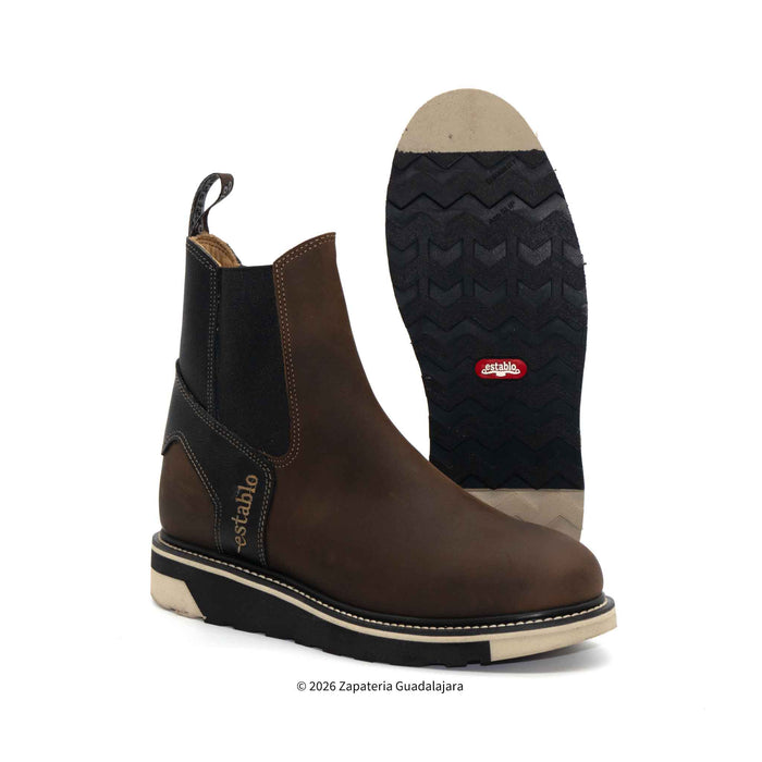 Brown boot with black sole on a white background