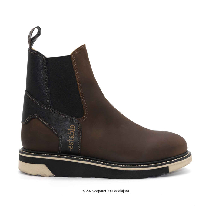 Brown Chelsea boot with black elastic side on a white background