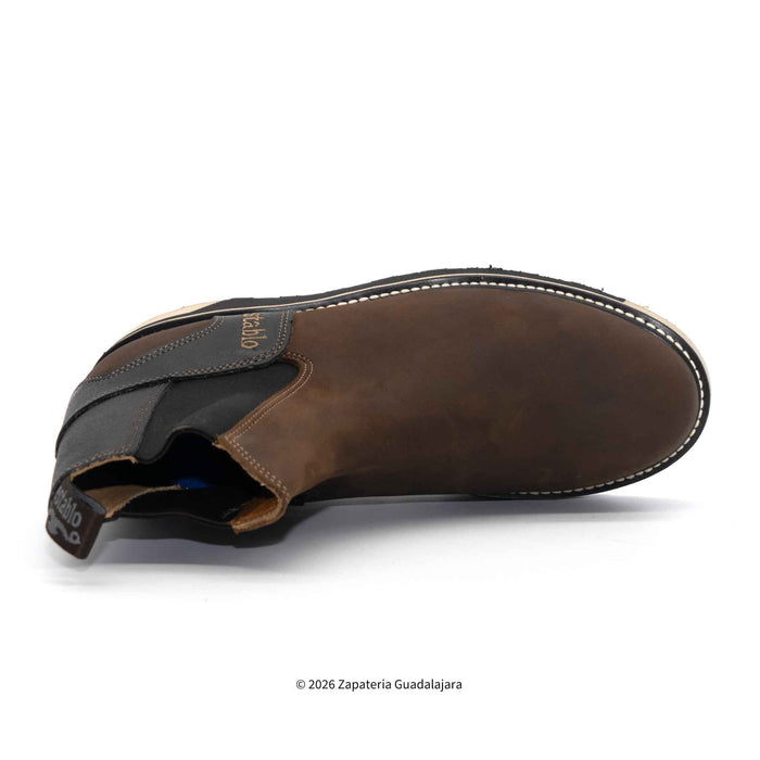 Brown leather boot on a white background