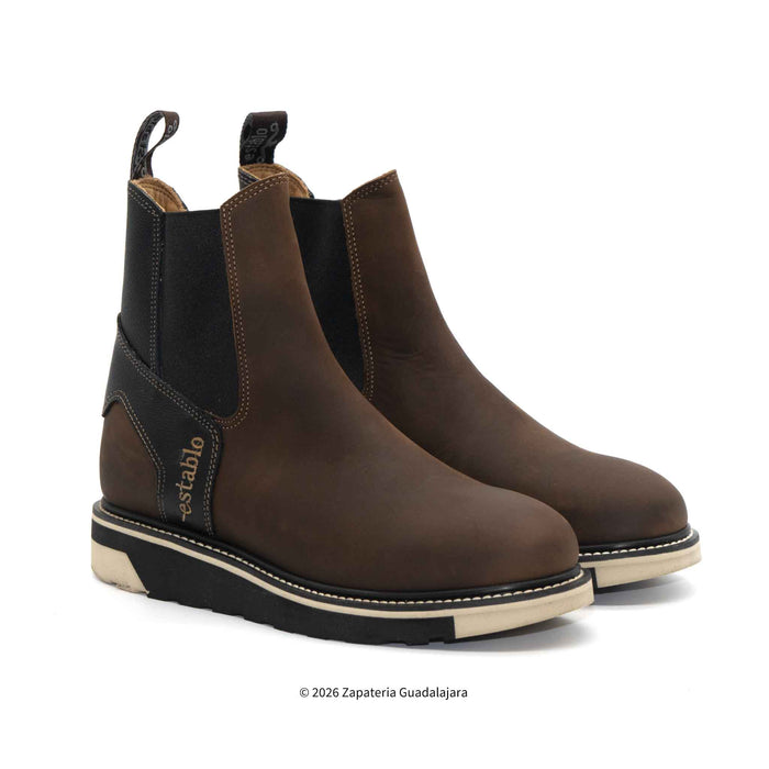 Pair of brown leather boots with black accents on a white background
