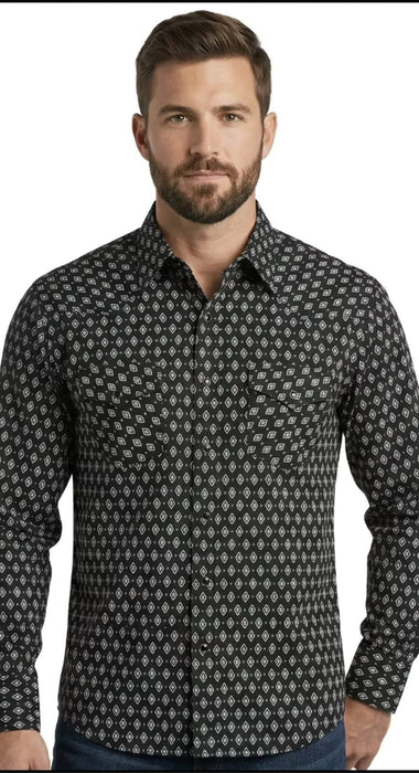 A man wearing a long-sleeve button-down shirt with a small repeating geometric pattern in black and white, shown against a plain white background.