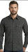 A man wearing a long-sleeve button-down shirt with a small repeating geometric pattern in black and white, shown against a plain white background.