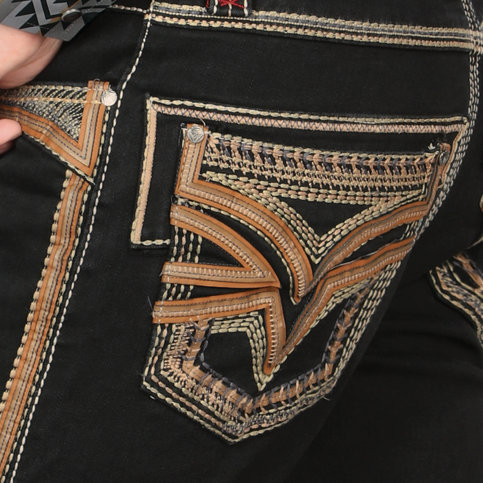 Close-up of a black jacket with intricate brown and beige embroidery on a pocket.