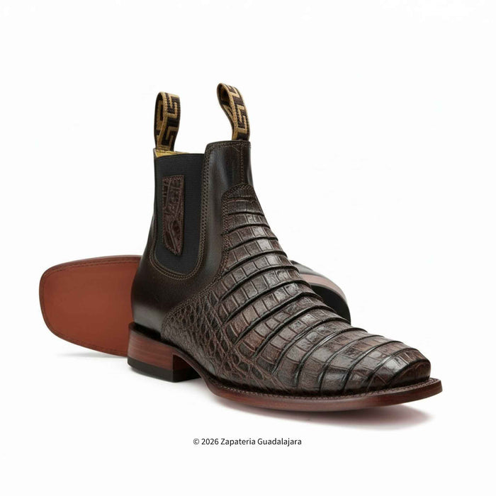 a pair of brown caiman belly leather boots