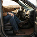 Person sitting inside a vehicle with a scenic background