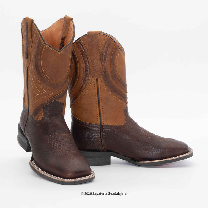 A pair of western cowboy boots in shades of brown leather, featuring a dark brown lower shaft and toe, and a lighter tan upper shaft with decorative stitching, shown against a plain white background.