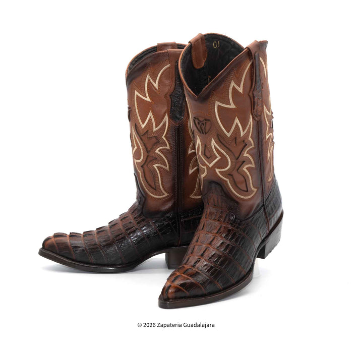 Brown cowboy boots with intricate designs on a white background