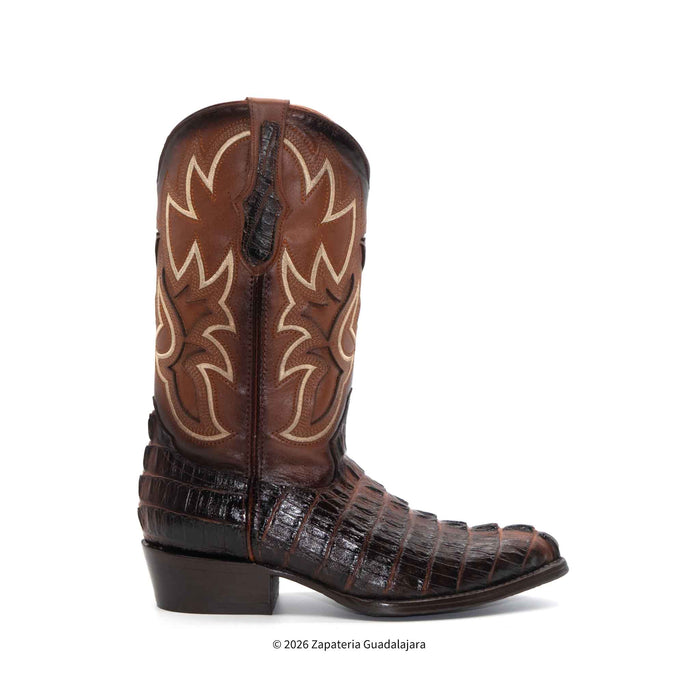 Brown cowboy boot with intricate design on a white background