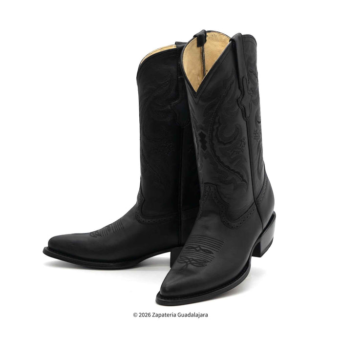 Black cowboy boots with intricate designs on a white background