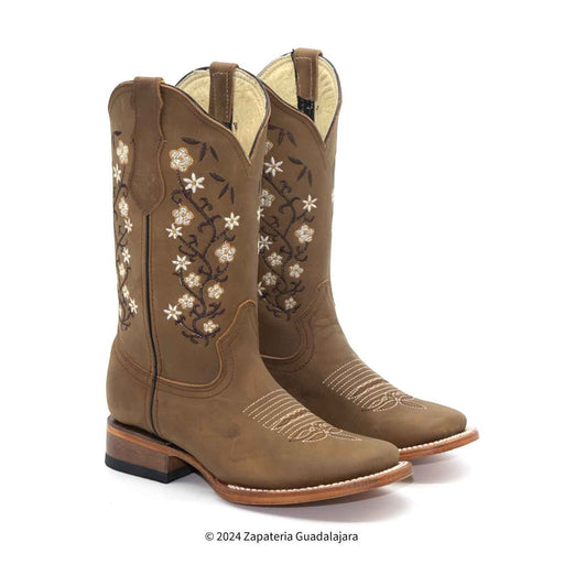 Brown cowboy boots with floral embroidery on a white background