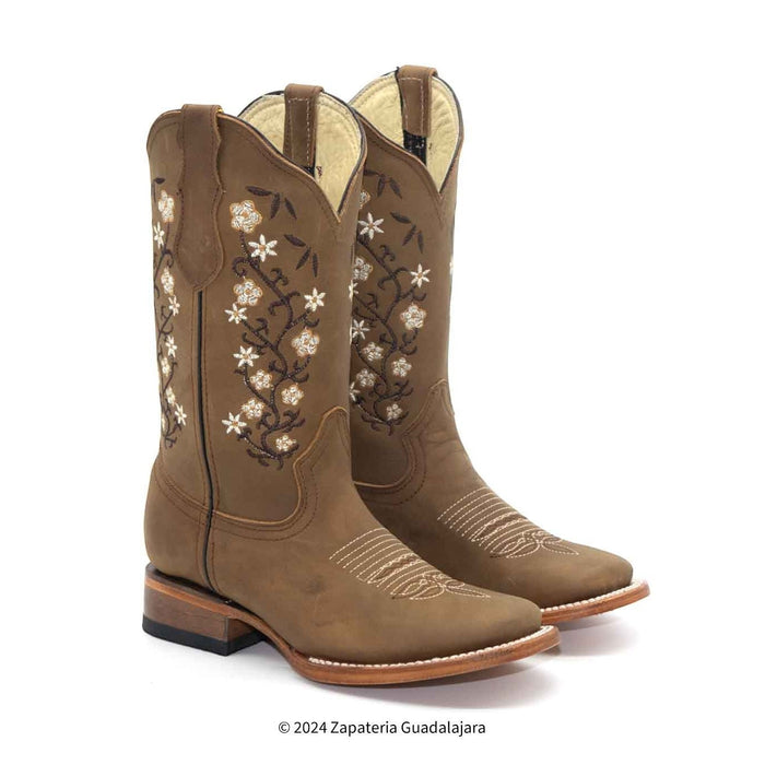 Brown cowboy boots with floral embroidery on a white background