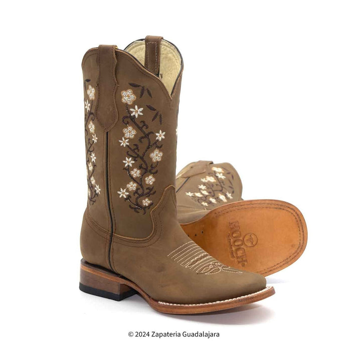 A pair of women's brown western boots with a square toe and floral embroidery, on a white background.
