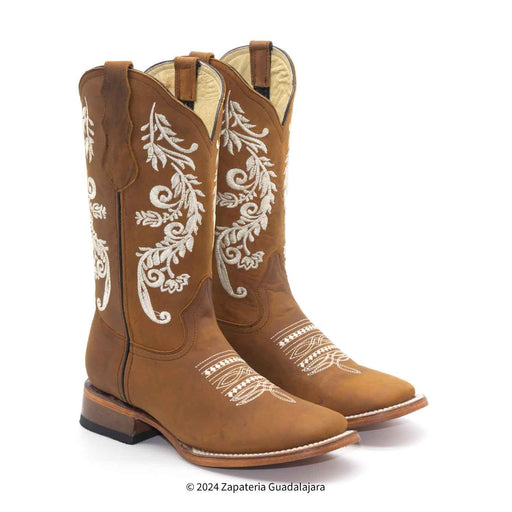 Pair of brown cowboy boots with white embroidery on a white background