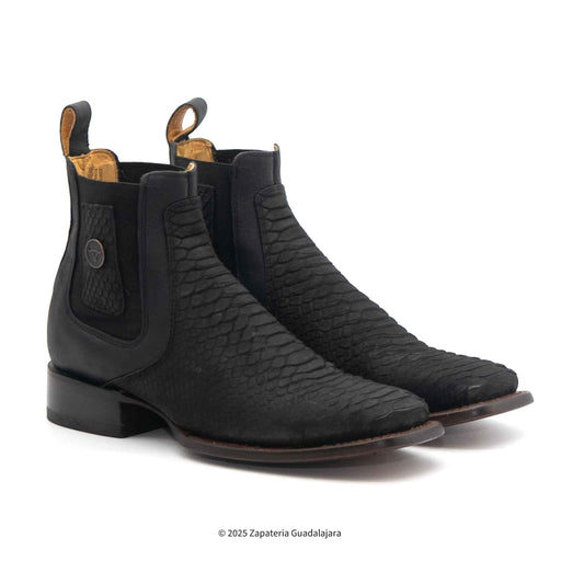 Pair of black leather boots with textured design on a white background