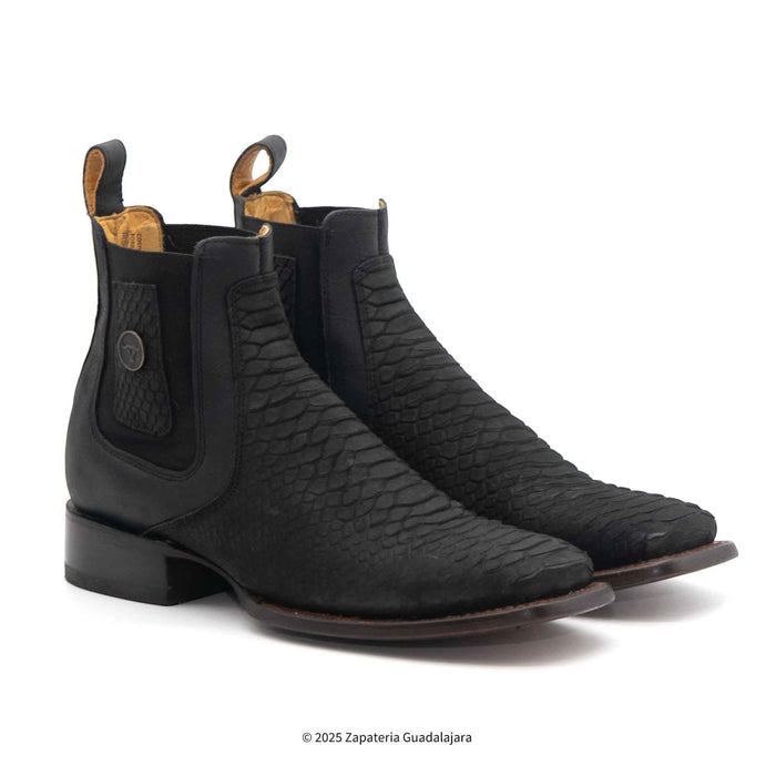 Pair of black leather boots with textured design on a white background