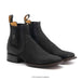 Pair of black leather boots with textured design on a white background