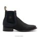 Black leather boot with a textured pattern on a white background