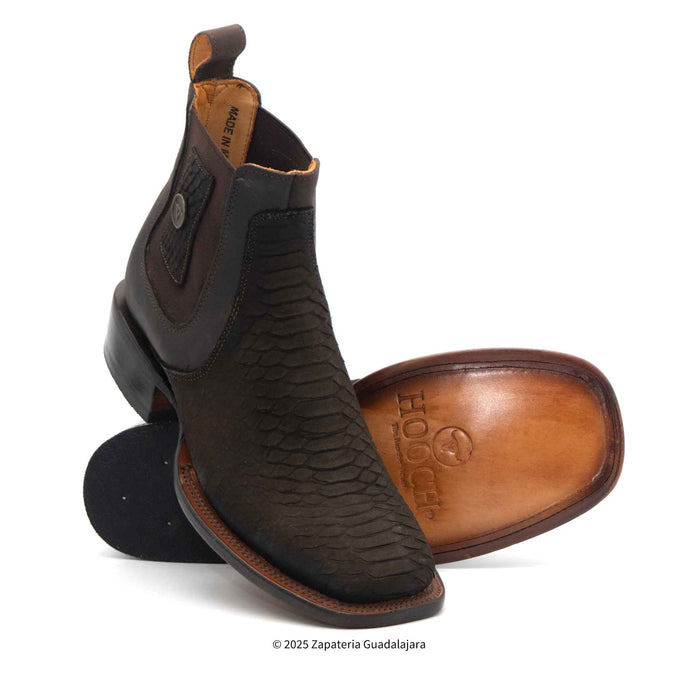 A pair of brown faux python leather men's cowboy boots with a wide square toe design.