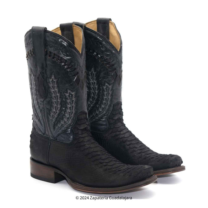 Pair of black cowboy boots with intricate design on a white background