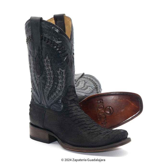 A pair of black western cowboy boots with textured leather and decorative stitching, shown on a white background with one boot standing upright and the other lying on its side to display the brown footbed.