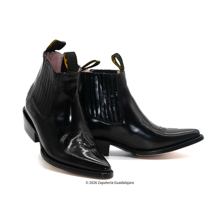 Pair of black leather boots on a white background
