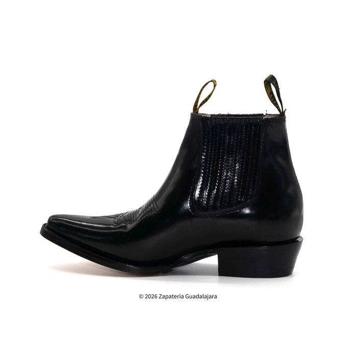 Black leather boot with a slight heel on a white background