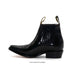 Black leather boot with a slight heel on a white background