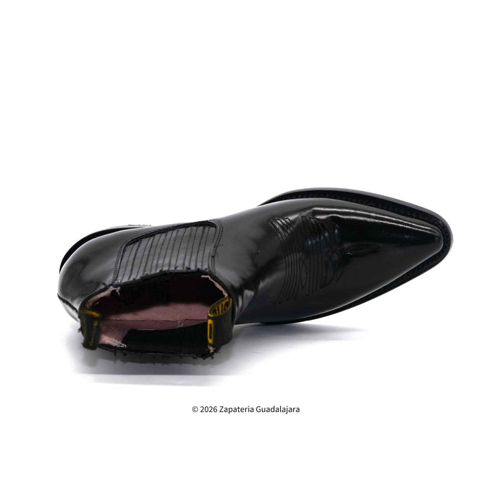 Black patent leather shoe on a white background