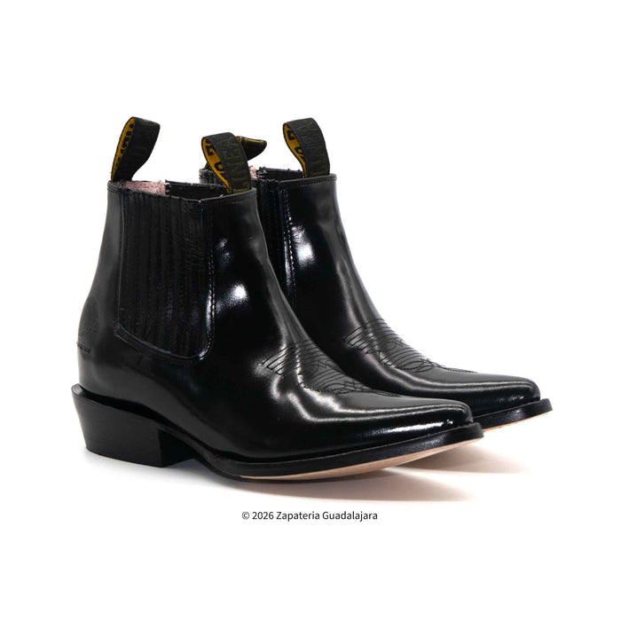 Pair of black leather boots on a white background