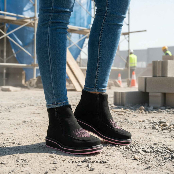 black leather women work boot with pink sole in a work site