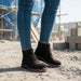 black leather women work boot with pink sole in a work site