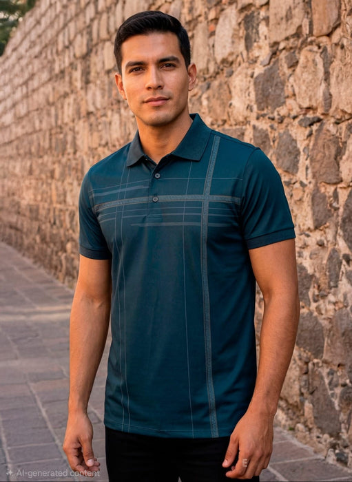 Man wearing a teal polo shirt standing against a stone wall.
