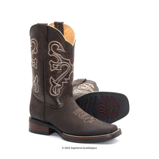 Brown cowboy boot with intricate white embroidery on a white background