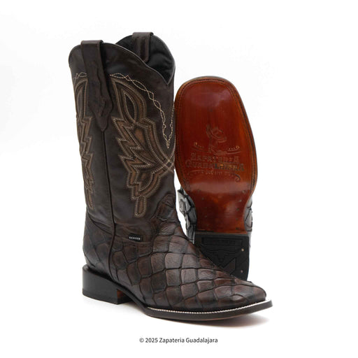 A pair of men's wide square toe faux pirarucu monster fish leather boots with a brown color and embossed pattern.