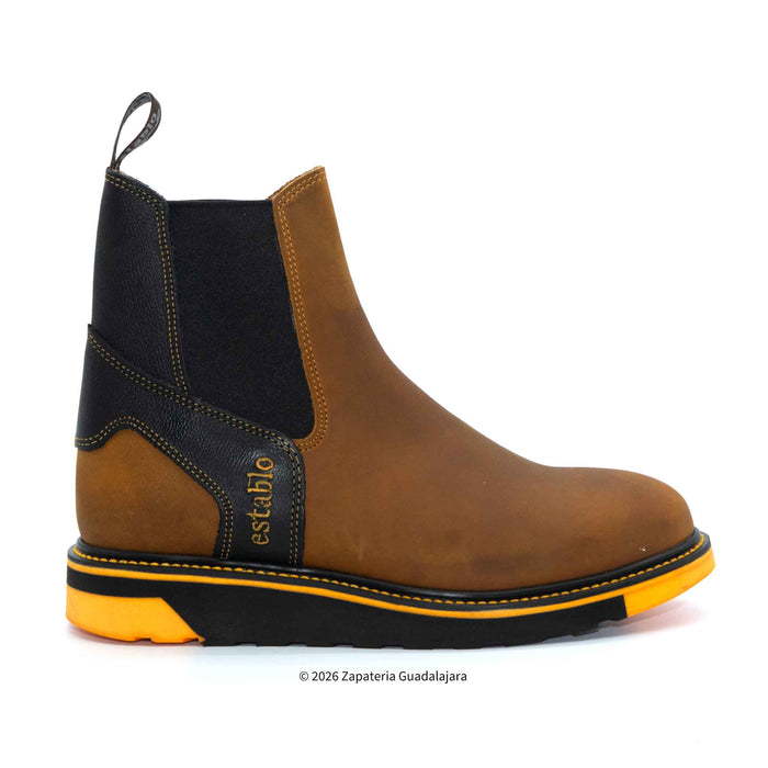 Brown Chelsea boot with black and yellow accents on a white background
